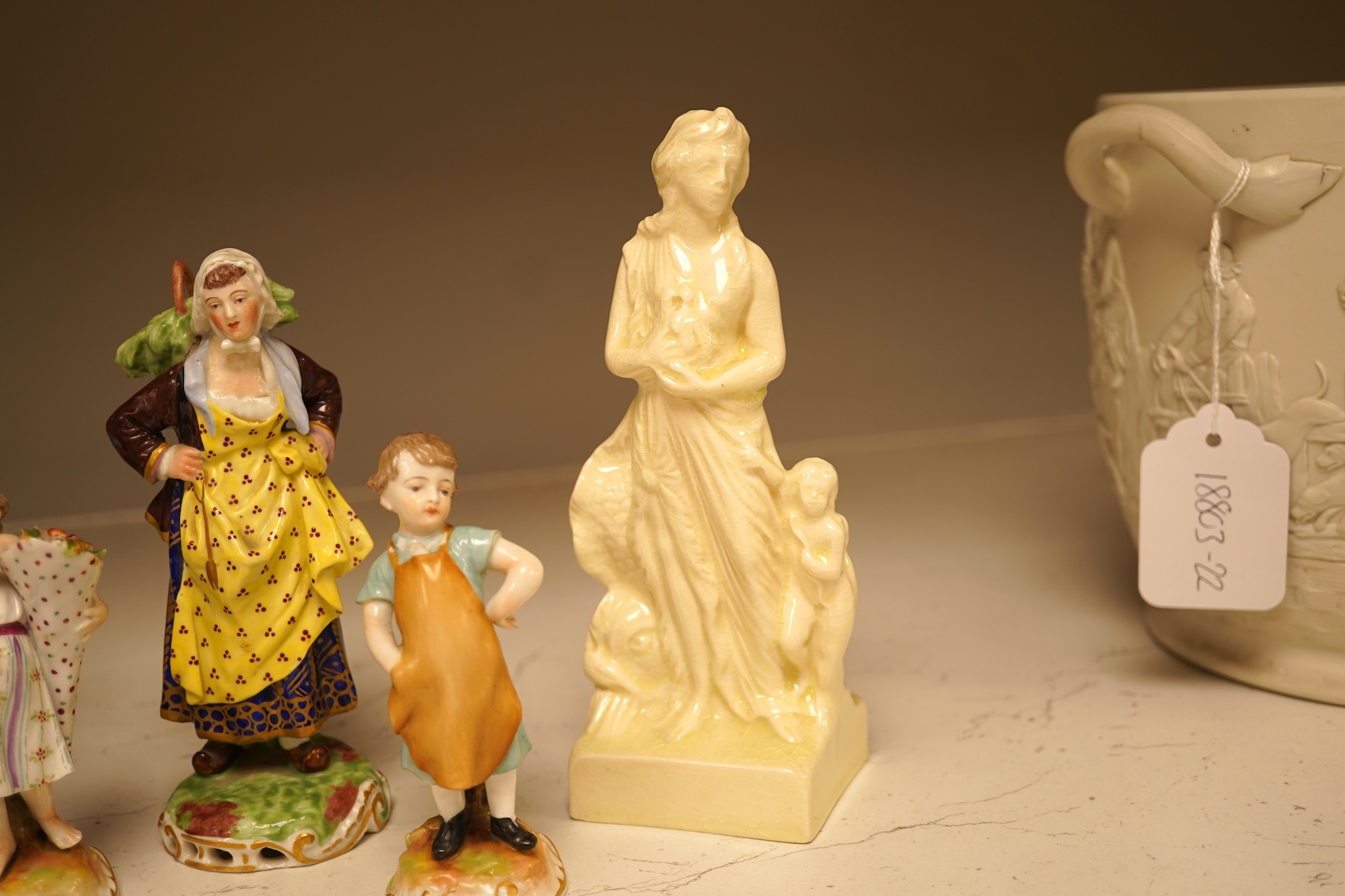 A pair of 19th century Meissen figurines, a Crown Derby figure, a pair of miniature figures and a Leeds type creamware group of Venus and Cupid, tallest 18cm high.